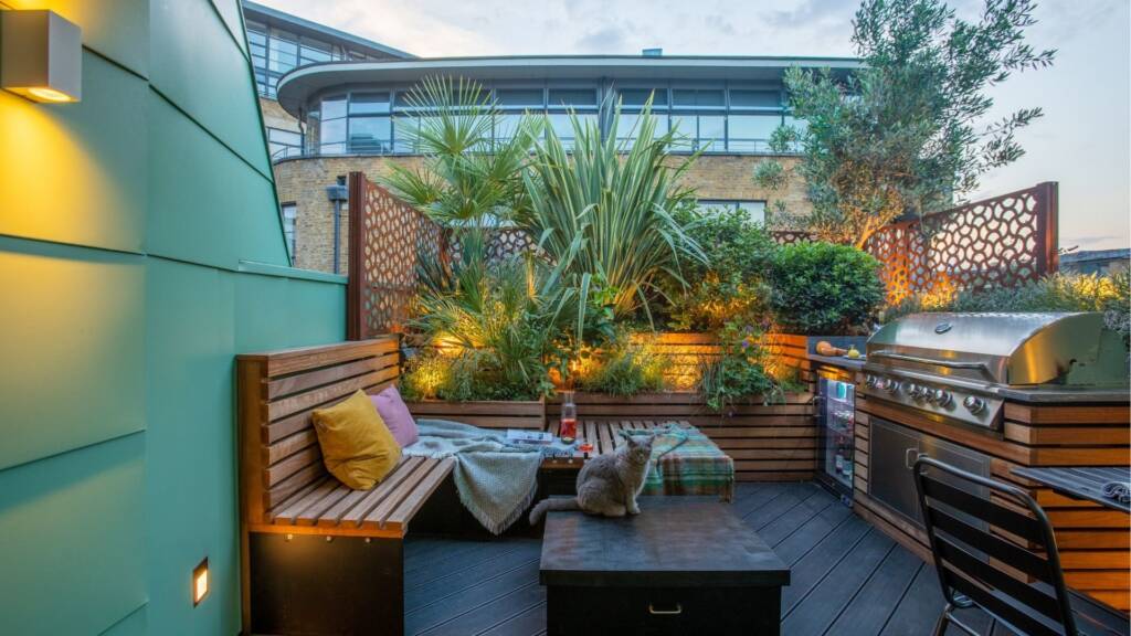 A cosy dining area with panelled floors and a light blue-green steel frame, set against the London skyline.
