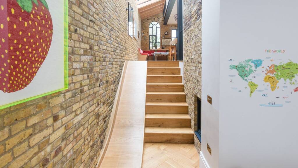 Slide detail beside reclaimed herringbone floor