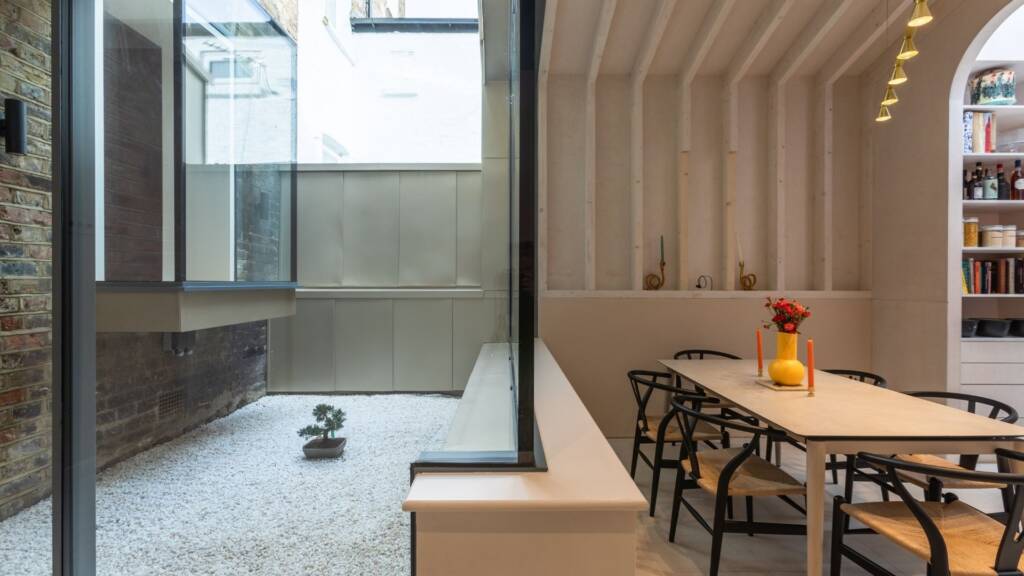 Minimalist planting in inner courtyard with brick backdrop