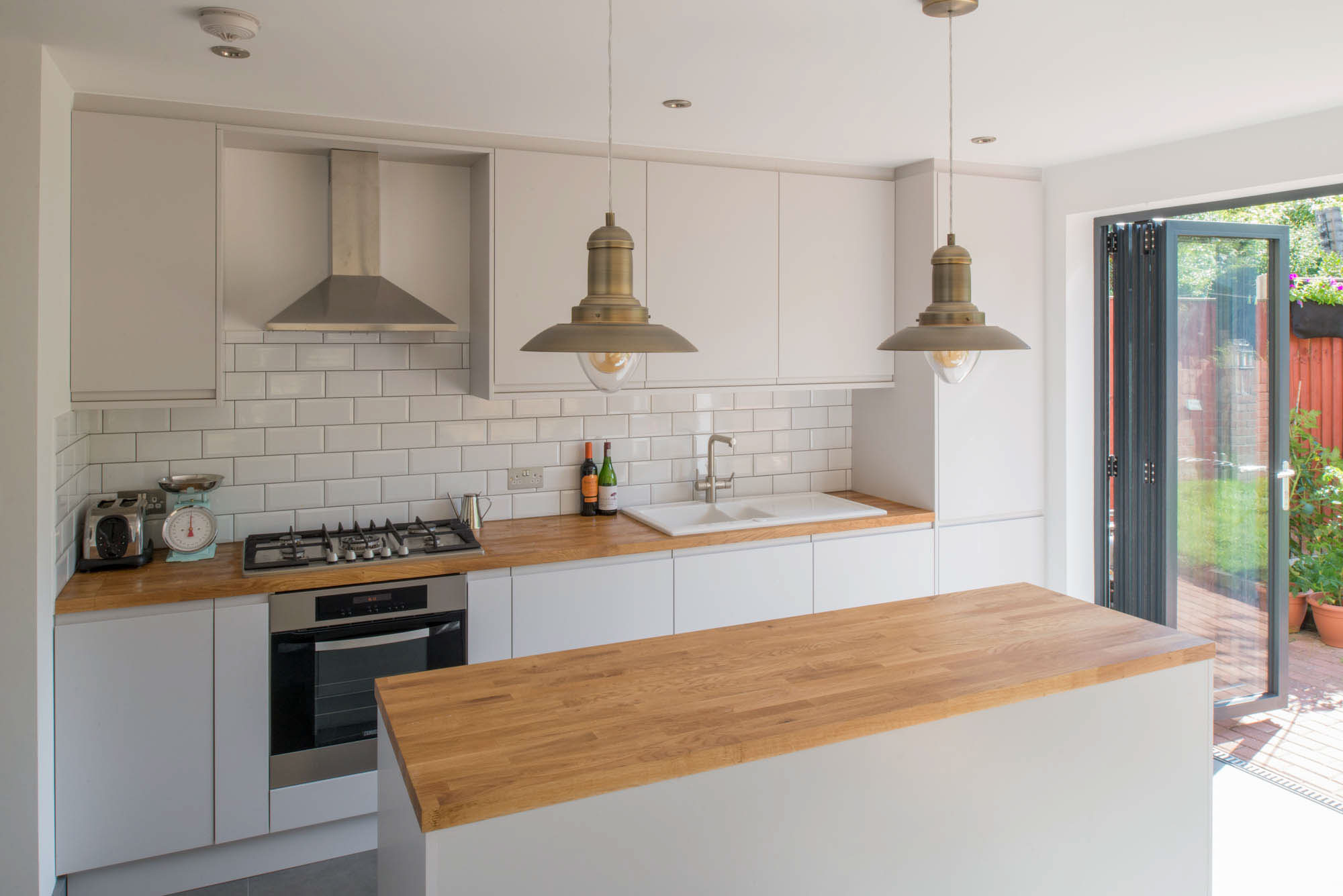 Alternate angle of the extension kitchen, showing the island and connection to the rest of the home