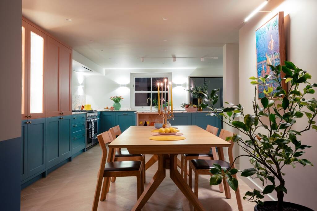 Bright dining room with lowered patio doors providing direct garden access, creating seamless indoor-outdoor entertaining space in a London home.