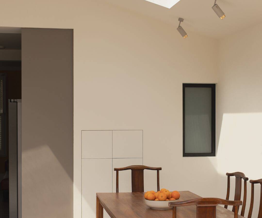 Architectural view of a conservation area extension in East London featuring striking high ceilings and an innovative double slanted roof.