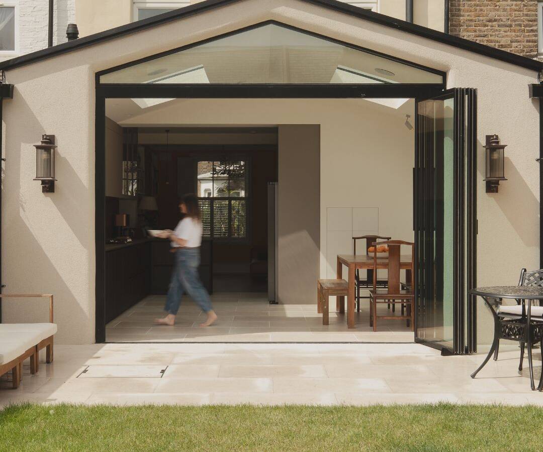 Bespoke triangular feature window at the peak of a conservation area extension, flooding the interior with natural night sky views.