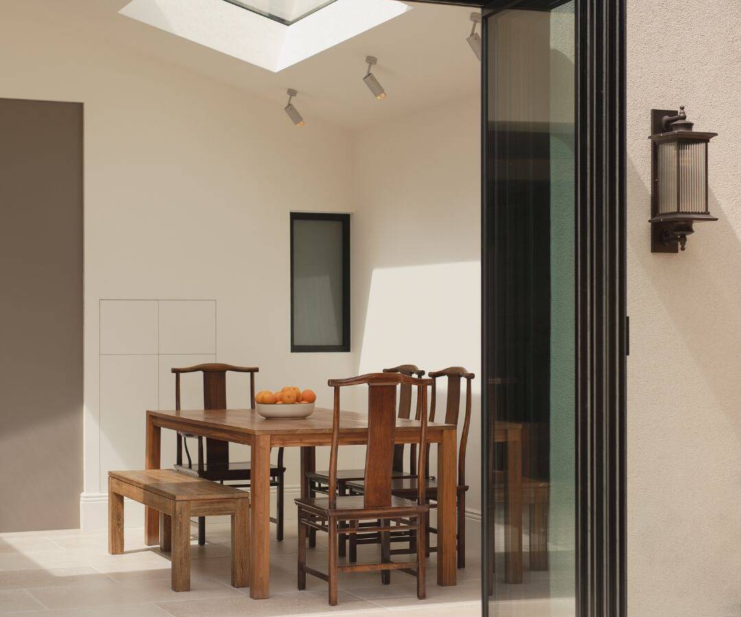 Spacious open plan dining area within a contemporary home extension in Stratford, perfectly accommodating a large family table.