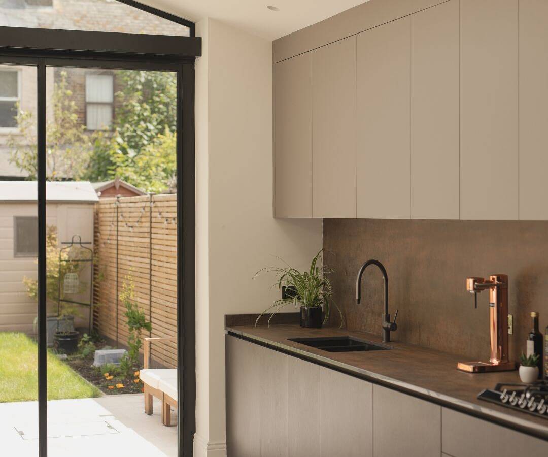 A completely hidden kitchen extractor system seamlessly integrated into a clean, modern worktop surface.