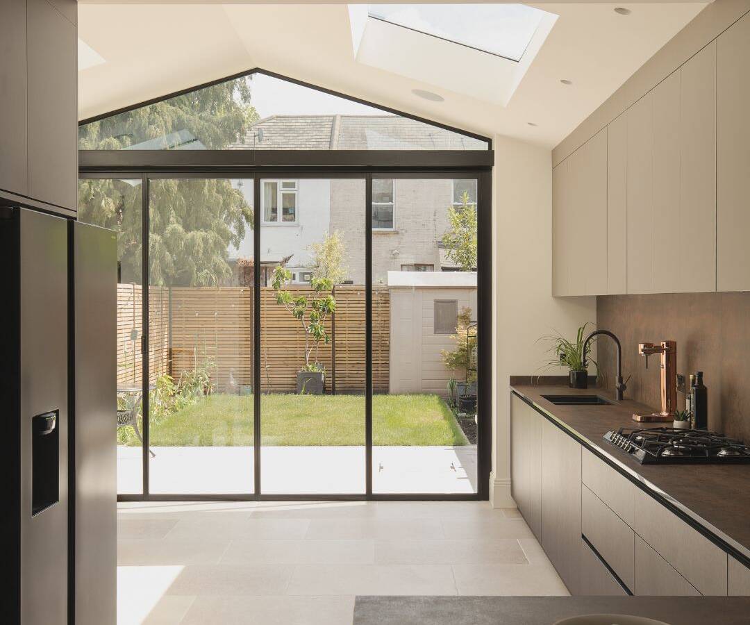 Reconfigured open plan ground floor layout in Newham, removing restrictive walls to create a fluid, continuous living space.