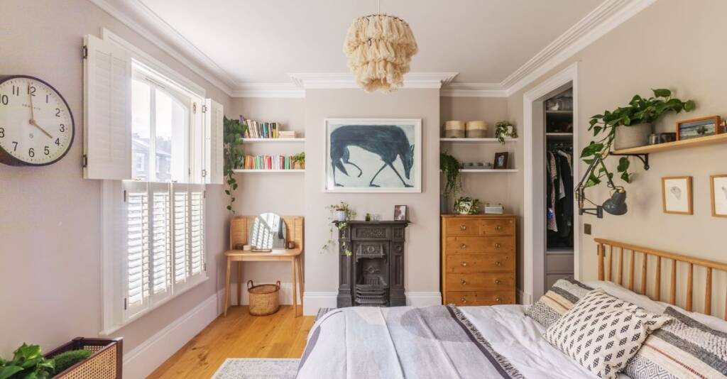 A Victorian house renovation bedroom featuring original period details